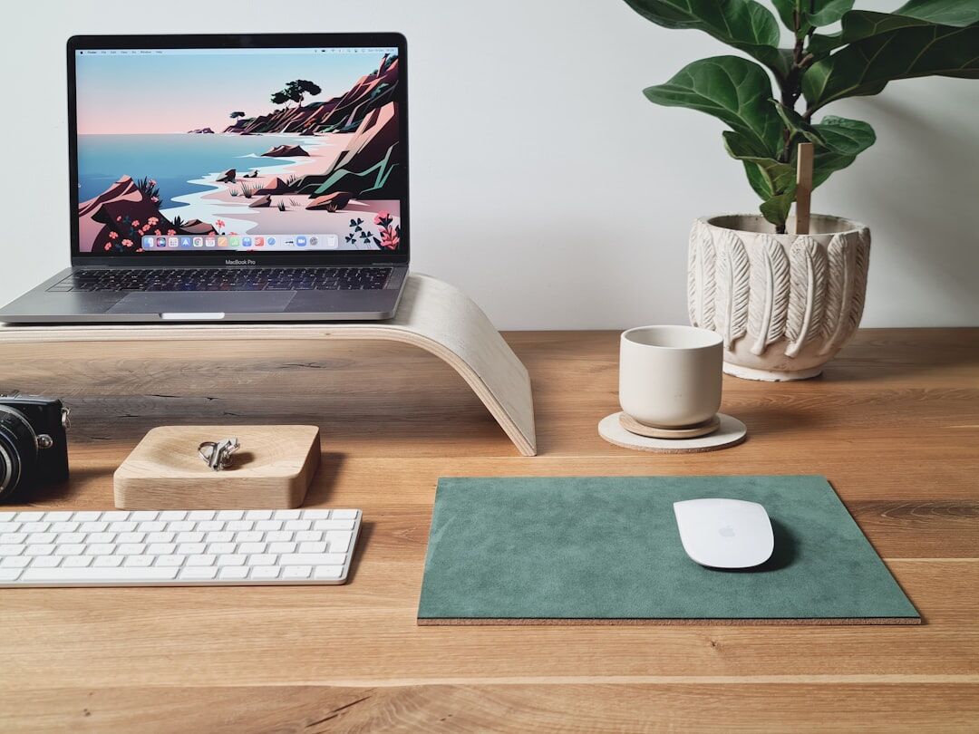 Minimalist office desk with laptop, notebook and coffee cup