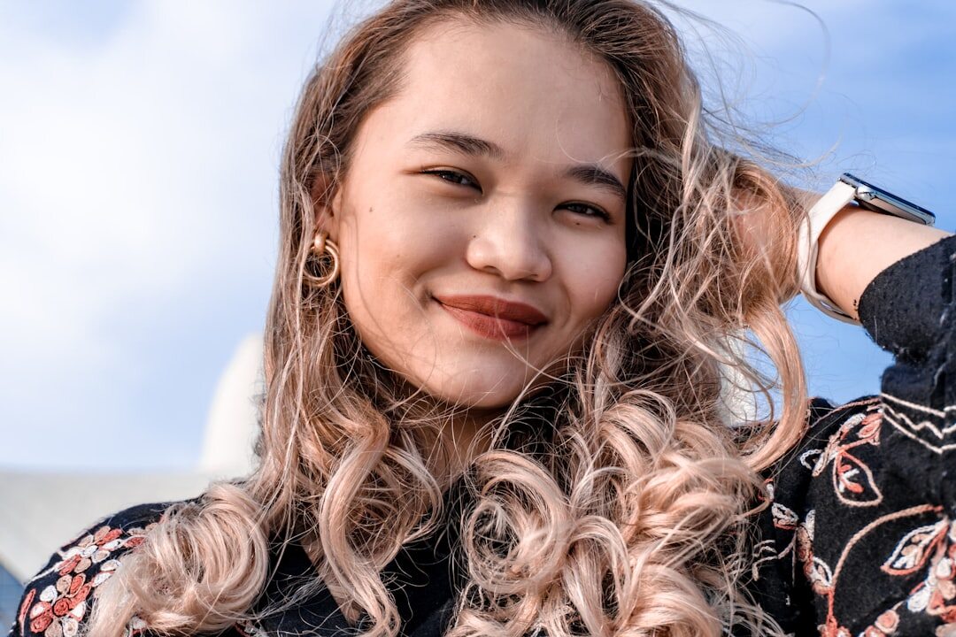 Belgian businesswoman with curly brown hair in a blazer